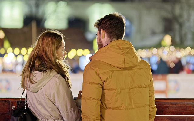 Couple sitting together on a bench having a difficult conversation